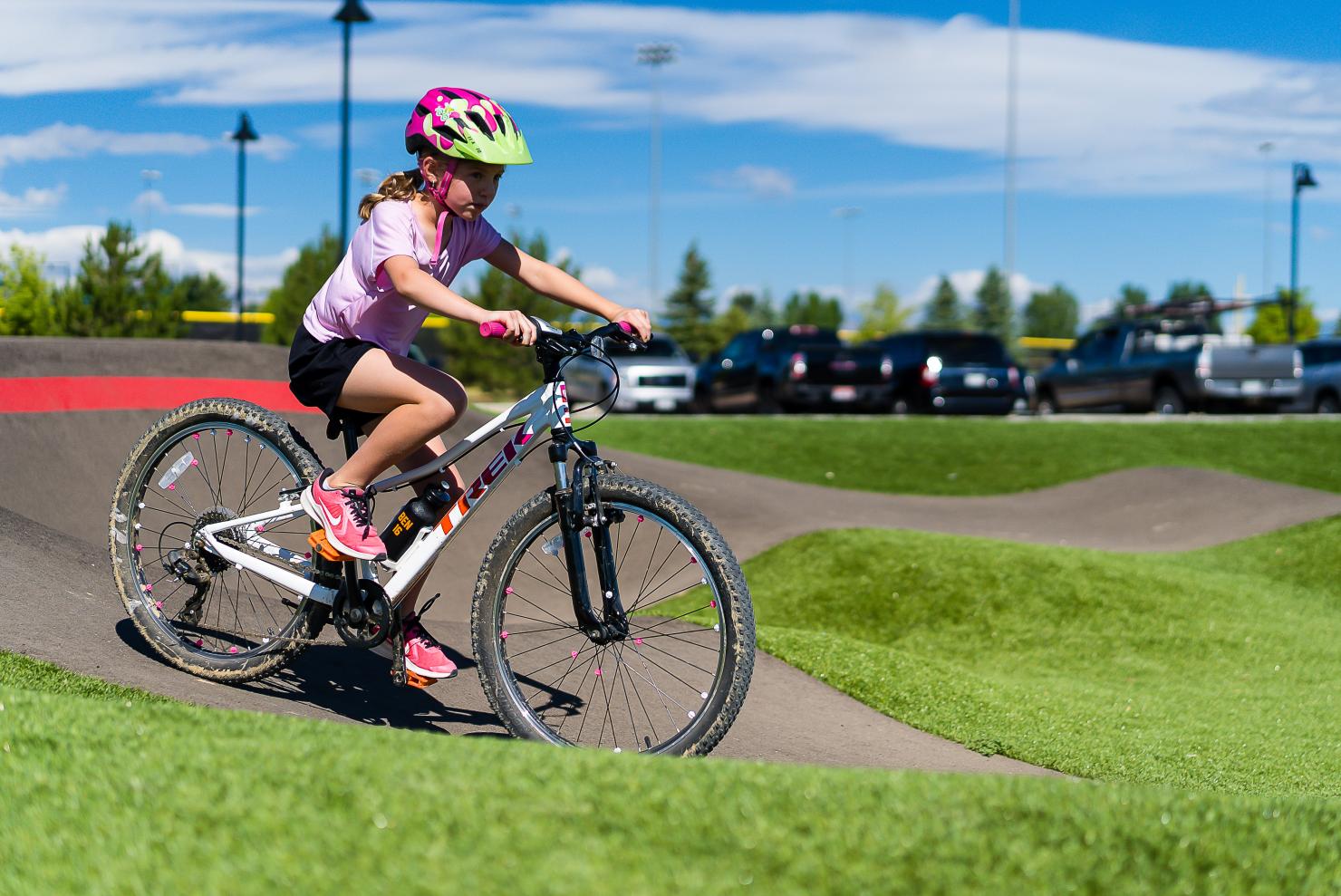 Young person rides a bike on the pump track.