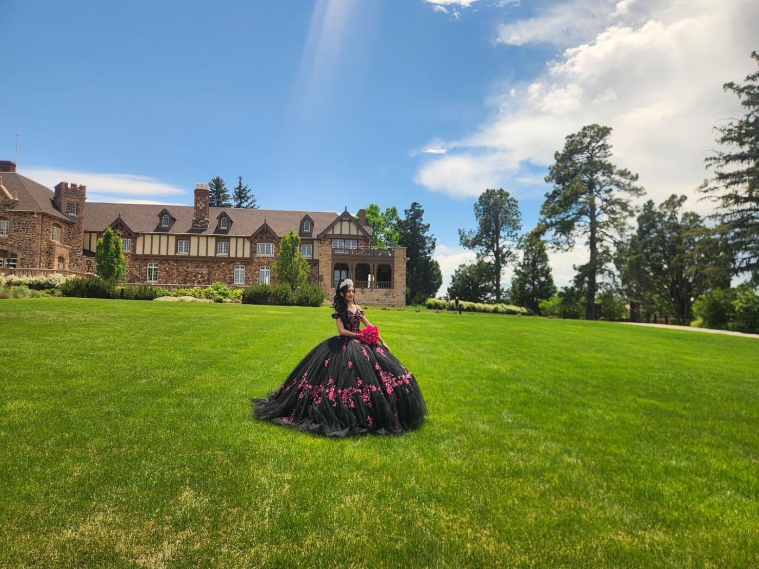 Daniela Carrillo in a quinceañera dress outside in a field. 