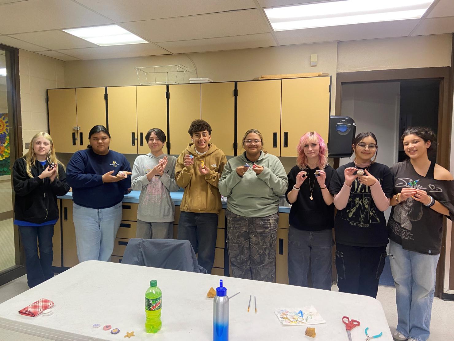 Members of GWD’s Green Team with their handmade clay sculptures. From left to right: Eniyah, Alondra, Sebastian, Taysen, Bella, Tahnee, Sol, and Mia.