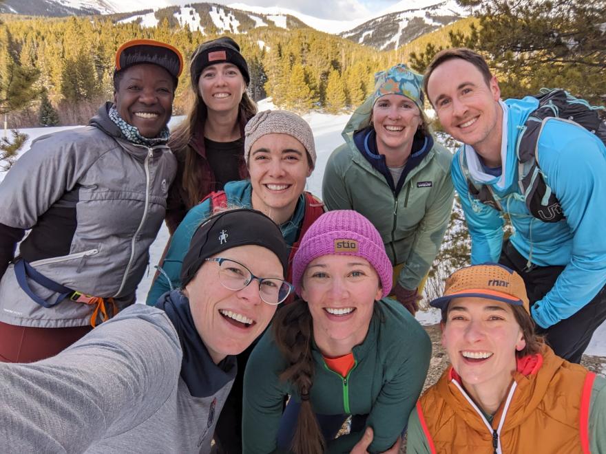 Jordan and friends selfie close up with snowy mountain backdrop.