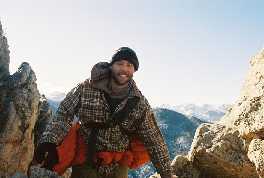 Payton Lockhart posing for a photo, on a rocky hike. 