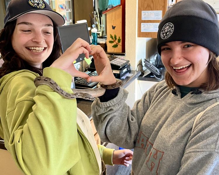 Emma and fellow YIP intern Leah McGill with a reptile ambassador. 