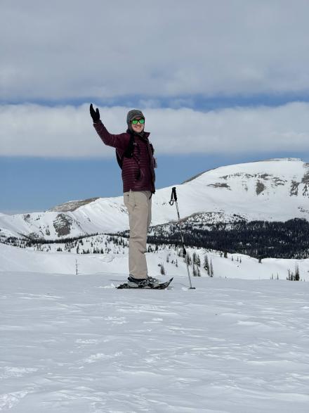 Jordan posing for a photo wile snowshoe hiking.