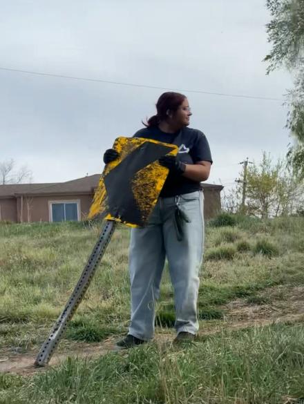 Bella at a trash clean up day removing an old abandoned sign.